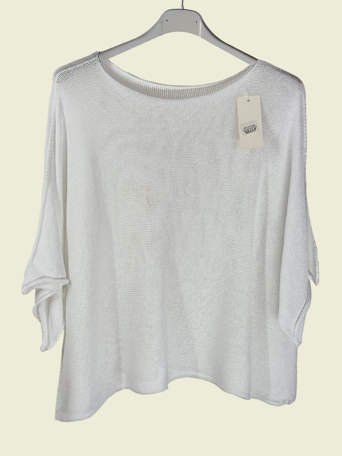 White sweater on a hanger 