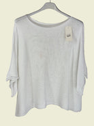 White sweater on a hanger 