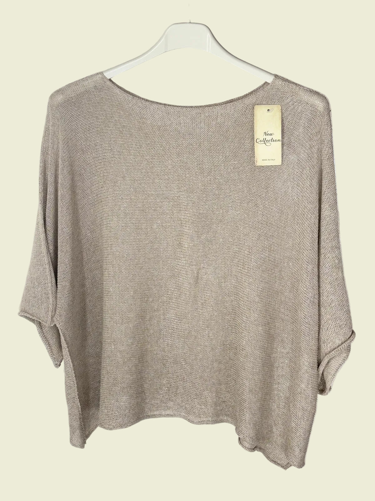 Beige sweater on a hanger 