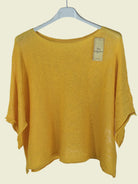 Yellow sweater on a hanger