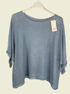 Blue sweater on a hanger 