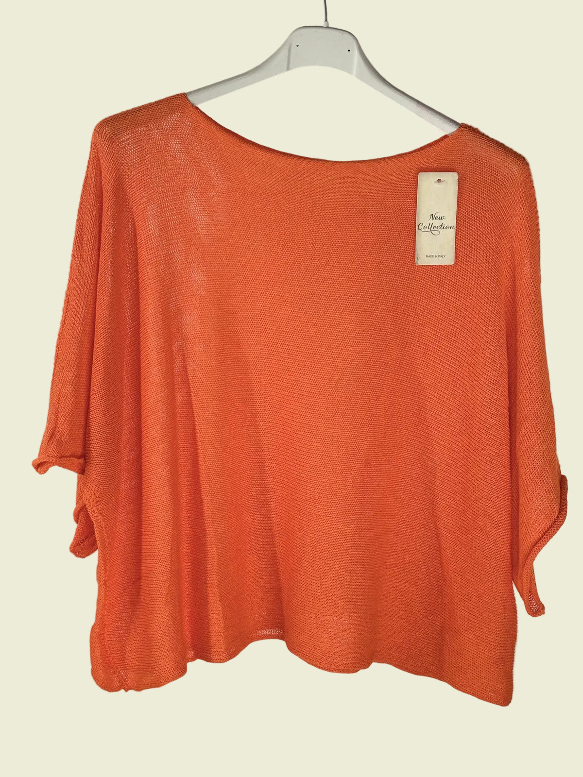 Orange sweater on a hanger 