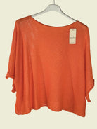 Orange sweater on a hanger 